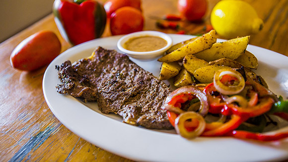 Pan Fried Pepper Steak Served with Potato Wedges